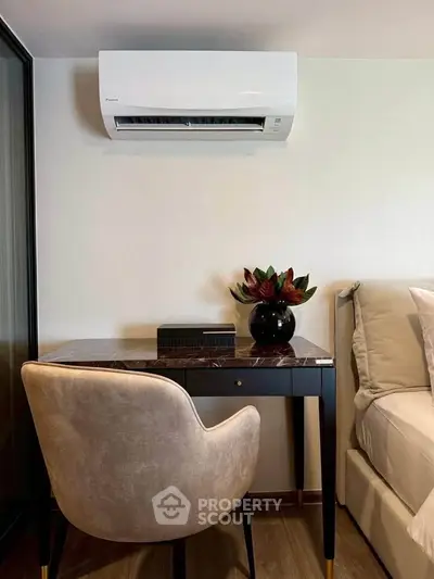 Modern bedroom with sleek desk and air conditioning unit, perfect for comfort and productivity.