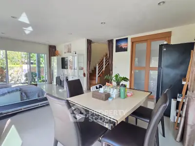 Spacious open-plan living and dining area with modern decor and natural light.