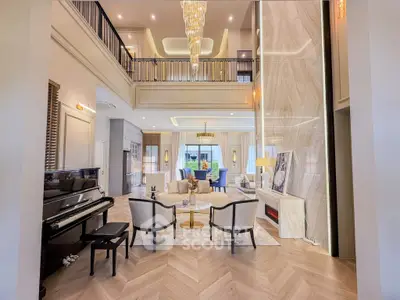 Luxurious living room with high ceilings, elegant chandelier, and grand piano in a modern home.