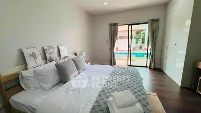 Luxurious bedroom with pool view and elegant decor in modern home