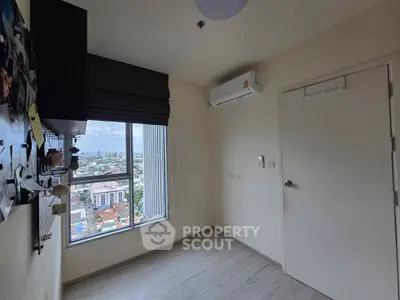Compact room with city view and air conditioning in modern apartment