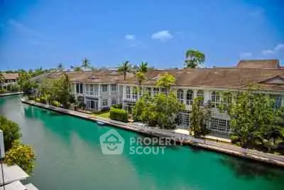 Stunning waterfront villas with lush greenery and serene canal view