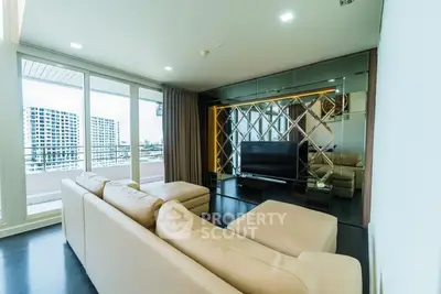 Luxurious living room with modern decor and large windows offering stunning city views.