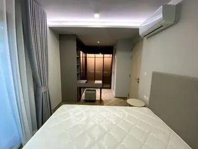 Modern bedroom with walk-in closet and air conditioning, featuring elegant curtains and neutral tones.