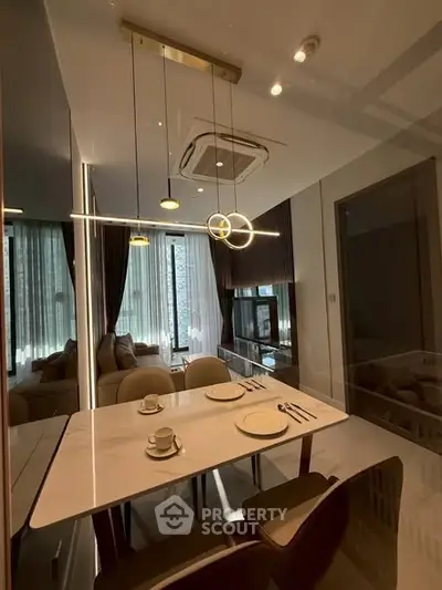 Modern dining area with elegant lighting and stylish decor in a contemporary apartment.
