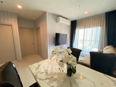 Modern living room with marble table and large window view in high-rise apartment