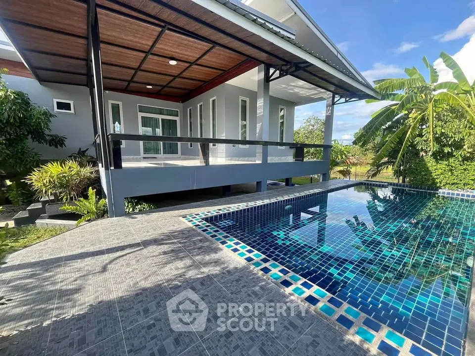 Modern home with private pool and lush garden, perfect for luxury living.