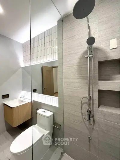 Modern bathroom with sleek shower and minimalist design in a contemporary apartment.