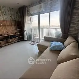 Spacious living room with large windows and balcony view