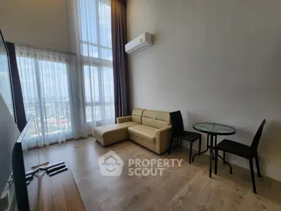 Modern living room with high ceilings and large windows offering a stunning view.