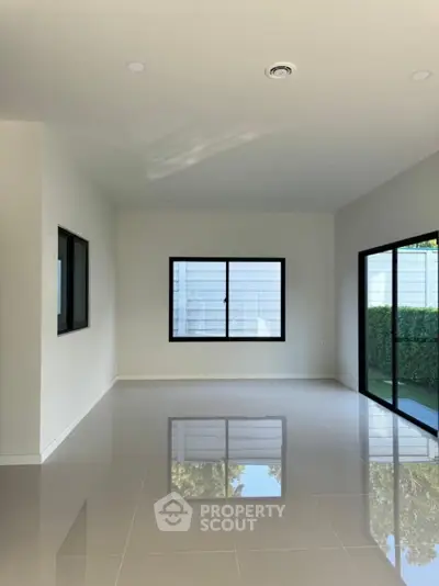 Spacious modern living room with large windows and garden view