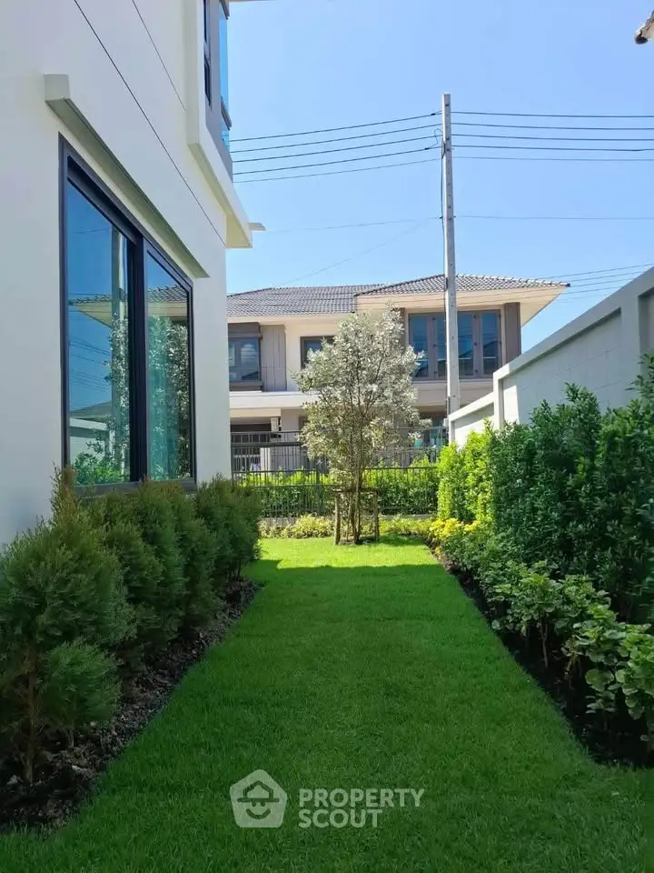Charming garden view with lush greenery and modern house exterior