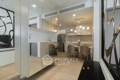 Modern dining area with sleek design and elegant lighting in a contemporary apartment.