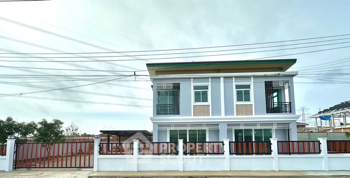Modern two-story house with sleek design and spacious fenced yard.