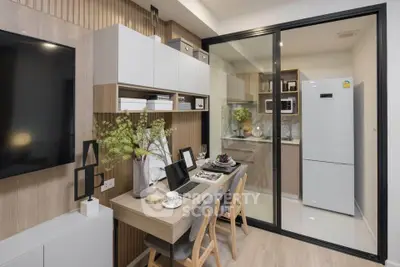 Modern living room with stylish decor and adjacent kitchen in open layout