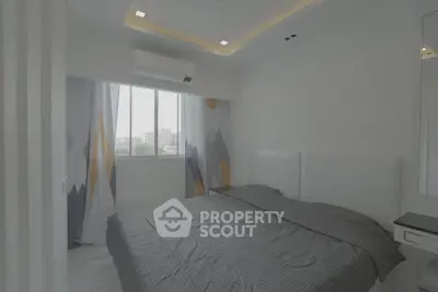 Modern bedroom with stylish decor and large window offering city views.