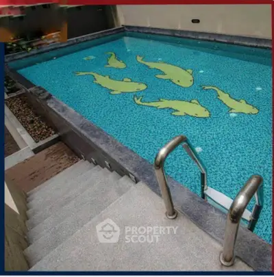 Luxurious swimming pool with unique fish design tiles and elegant steps.