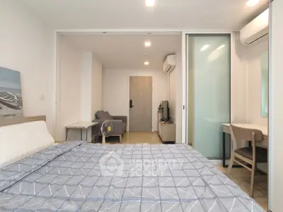 Modern bedroom with stylish decor and sliding glass doors in a cozy apartment.