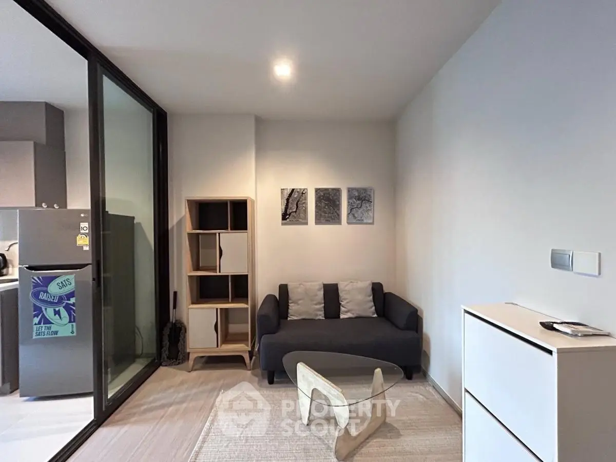 Modern living room with sleek furniture and glass partition, perfect for urban living.