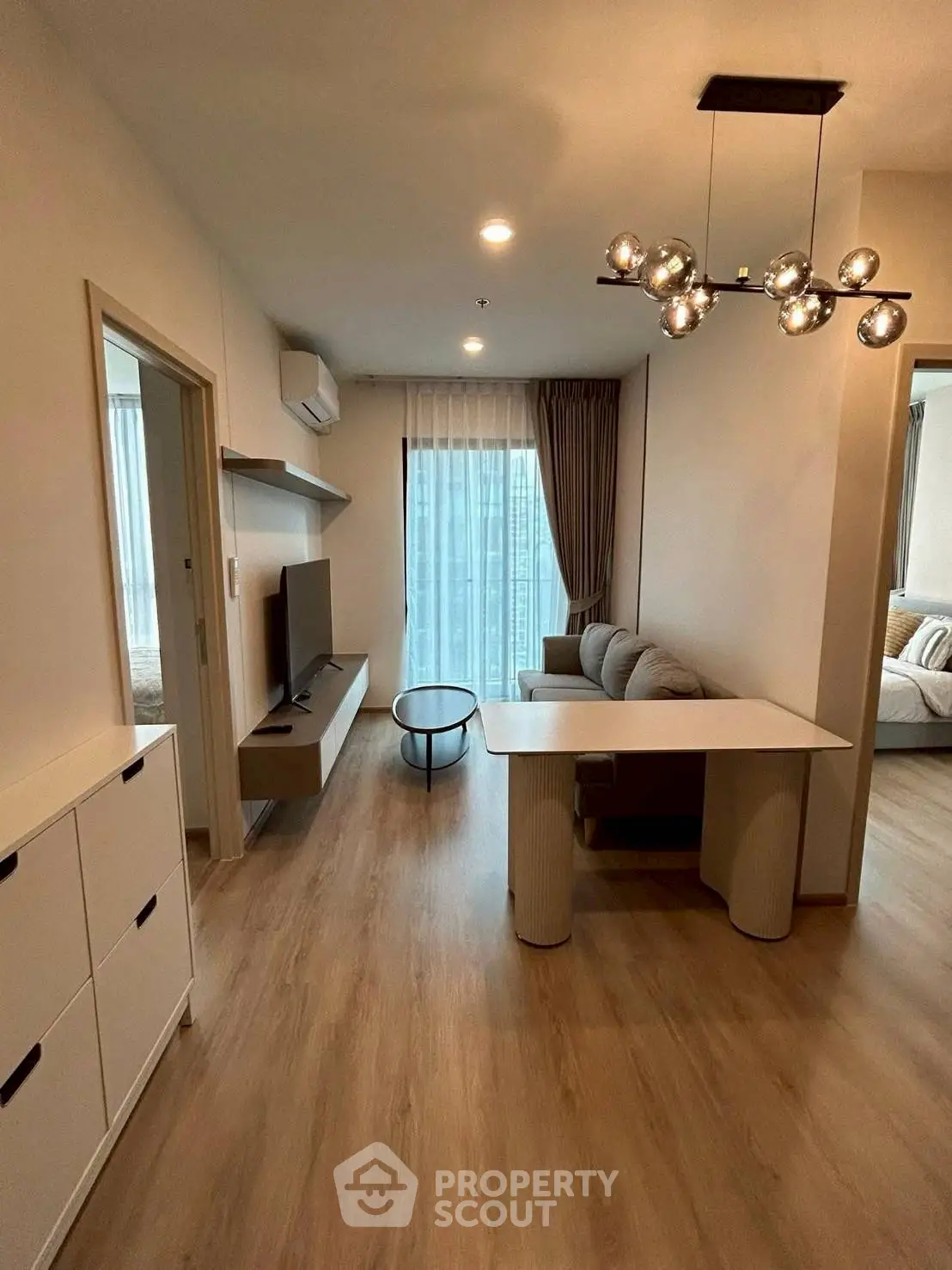 Modern living room with stylish lighting and cozy seating area in a contemporary apartment.