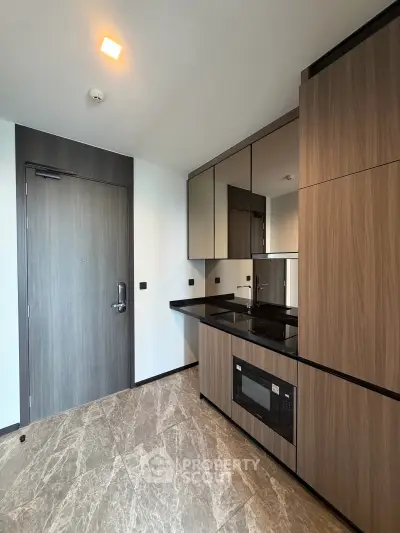 Modern kitchen with sleek cabinetry and built-in appliances in a stylish apartment.
