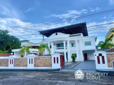 Luxurious white mansion with grand columns and spacious driveway