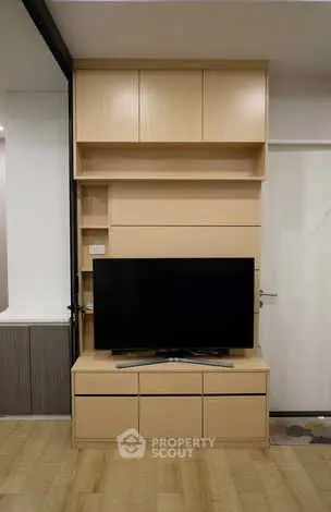 Modern living room with sleek wooden TV cabinet and flat-screen TV
