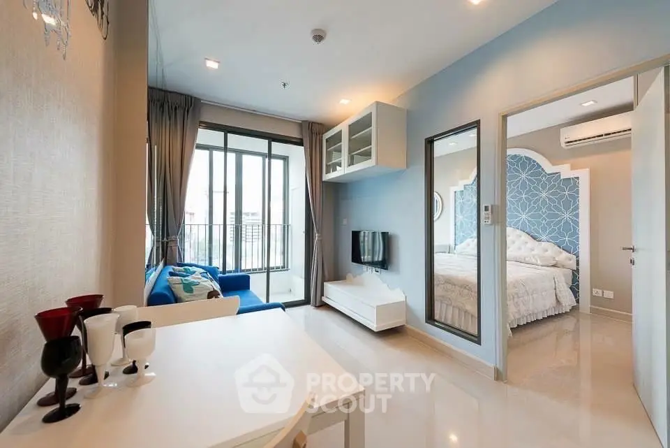 Modern apartment interior with living room and bedroom, featuring stylish decor and natural light.