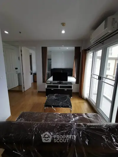 Modern living room with large windows and sleek furniture in a stylish apartment.