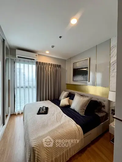 Modern bedroom with stylish decor and natural light in a contemporary apartment.