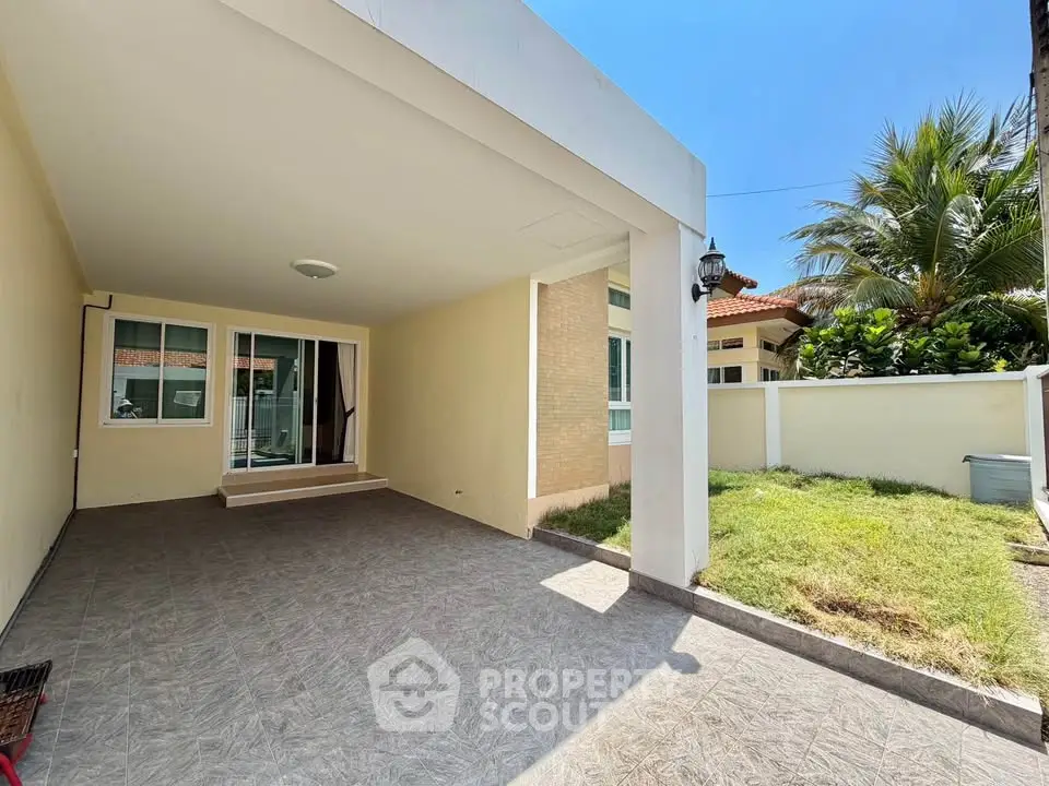 Spacious covered parking area with lush garden in modern residential property