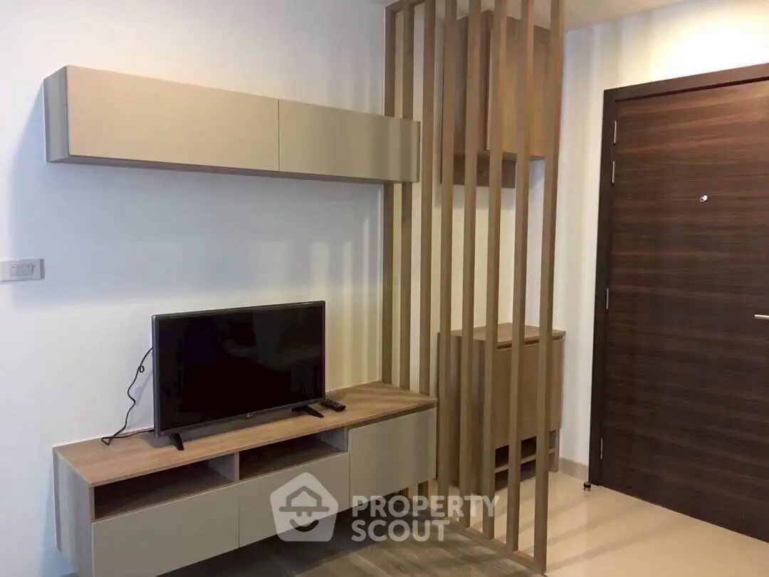 Modern living room with sleek TV unit and stylish wooden partition