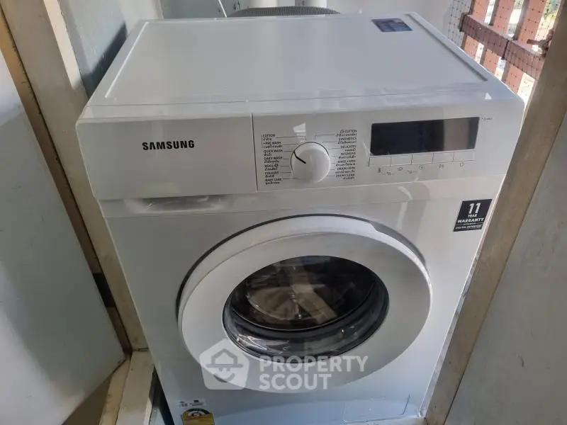 Modern Samsung washing machine in a utility area, perfect for efficient laundry solutions.