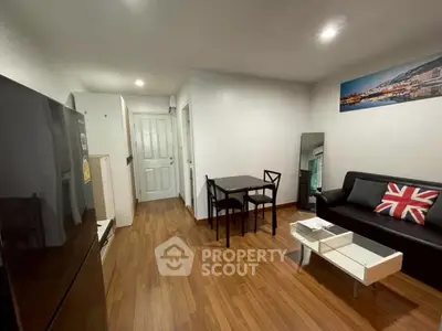 Modern living room with wooden flooring, compact dining area, and stylish decor.