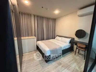 Modern bedroom with cozy bed, stylish decor, and ample natural light in a contemporary apartment.