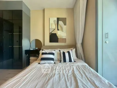 Modern bedroom with stylish decor and large window for natural light.