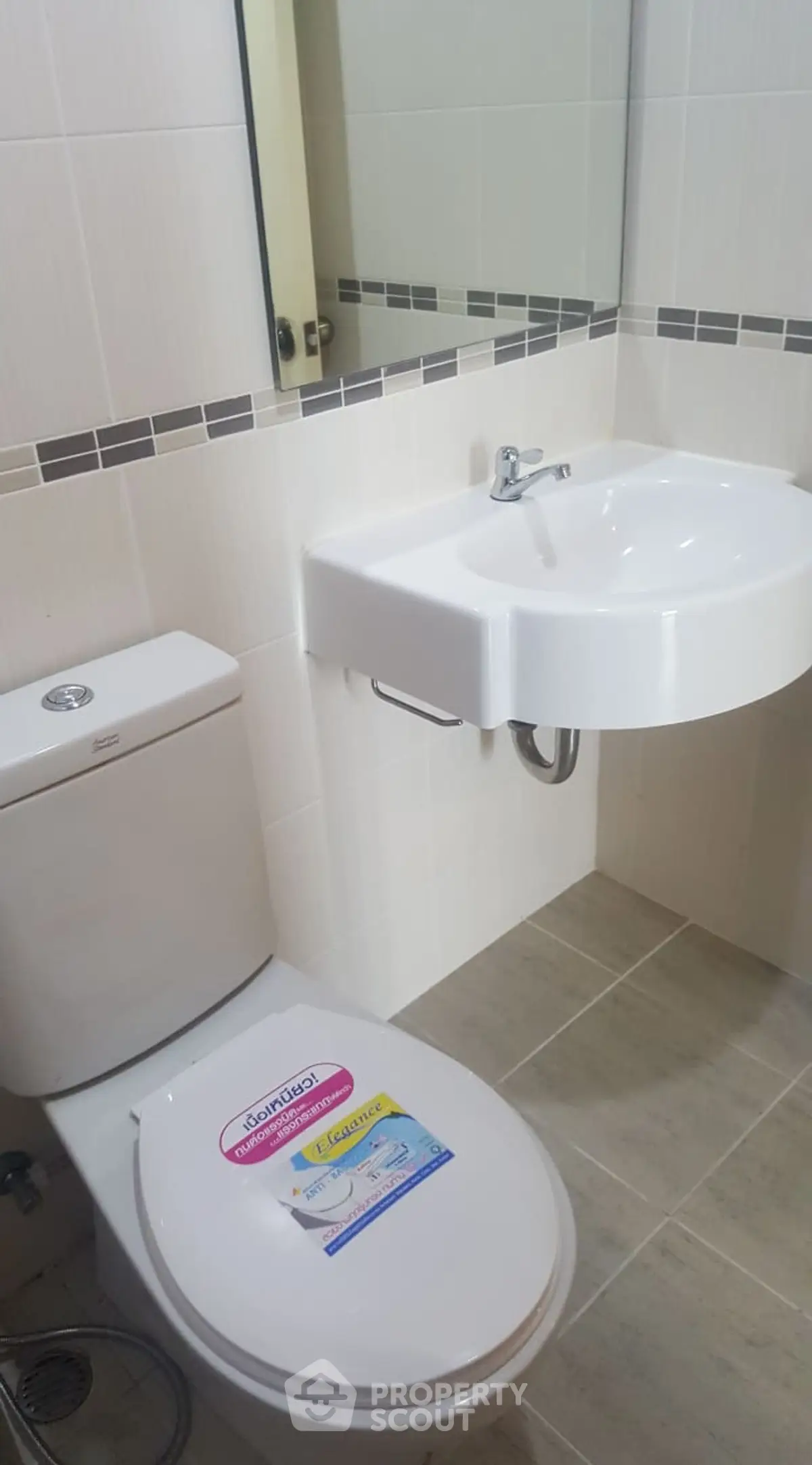 Modern bathroom with sleek white fixtures and stylish tile accents.