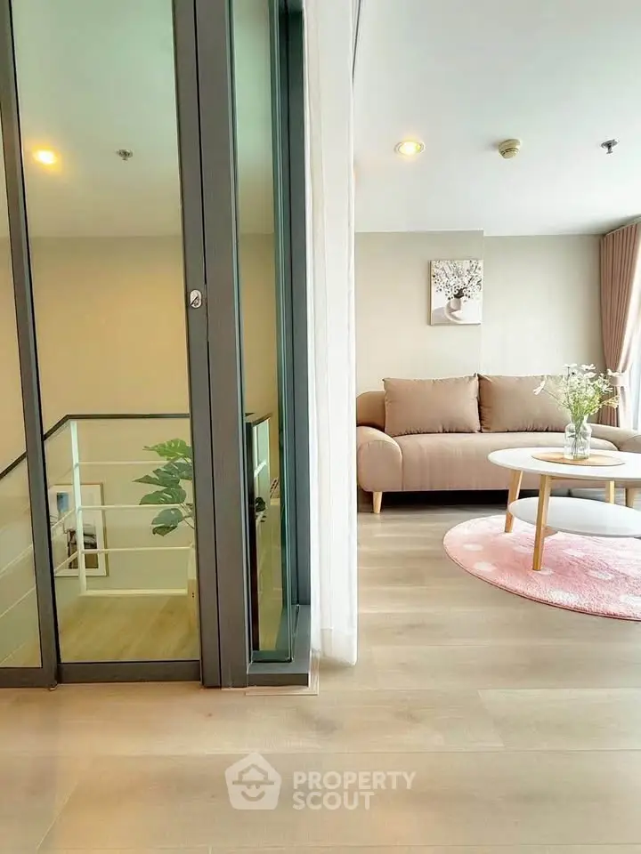 Modern living room with cozy sofa and stylish decor in a bright, open space.