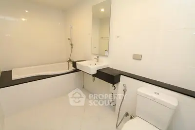 Spacious modern bathroom with sleek fixtures and bathtub