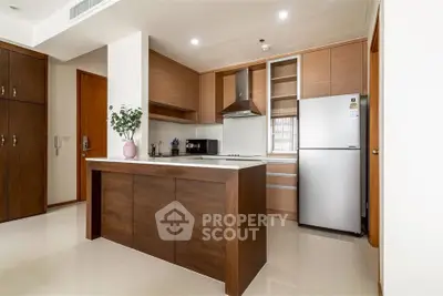 Modern kitchen with sleek wooden cabinets and stainless steel appliances