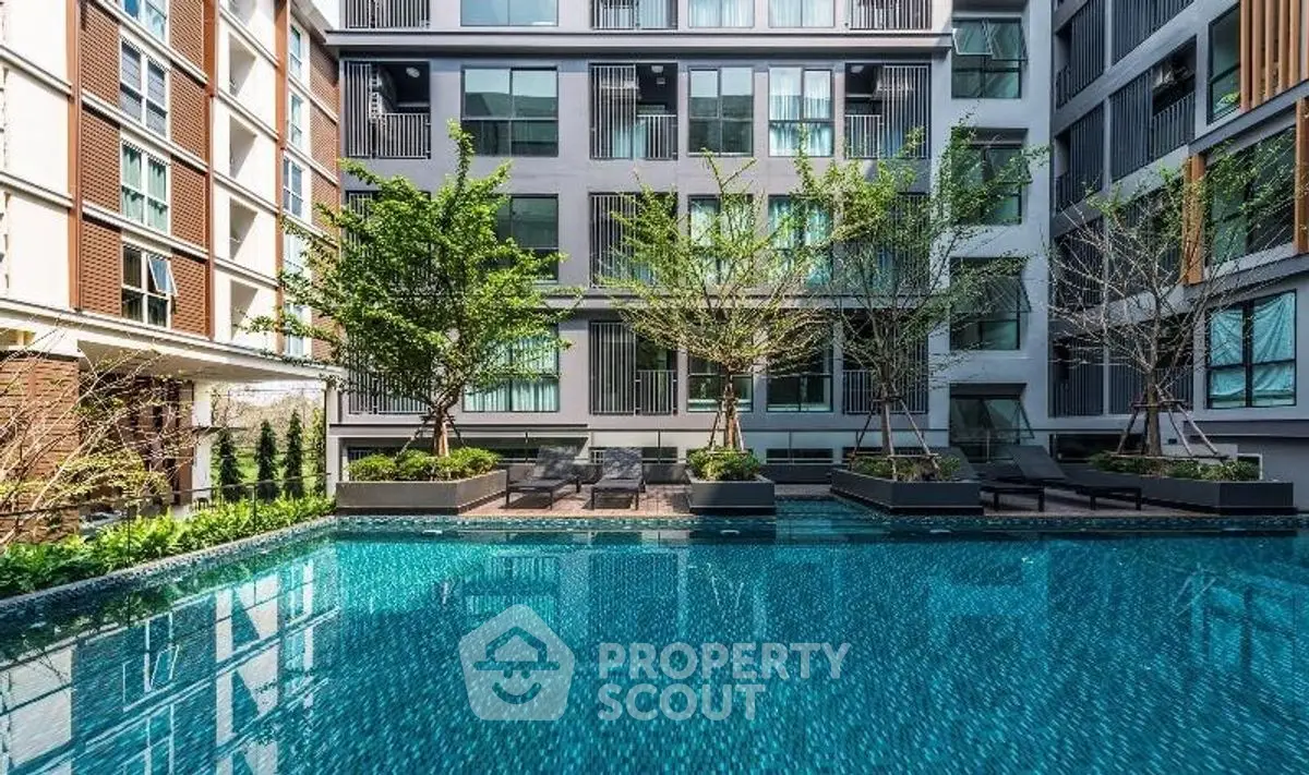 Luxurious modern apartment complex with stunning pool and lush greenery