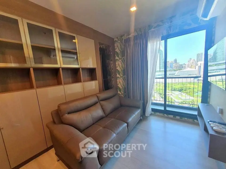 Modern living room with city view, featuring sleek sofa and built-in storage, perfect for urban living.