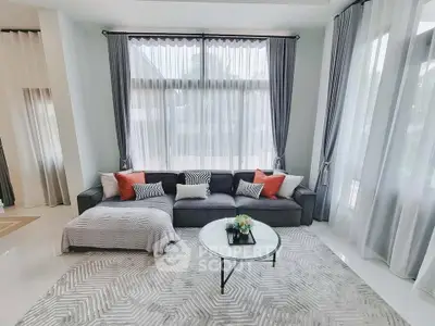 Spacious living room with elegant decor and large windows for natural light.