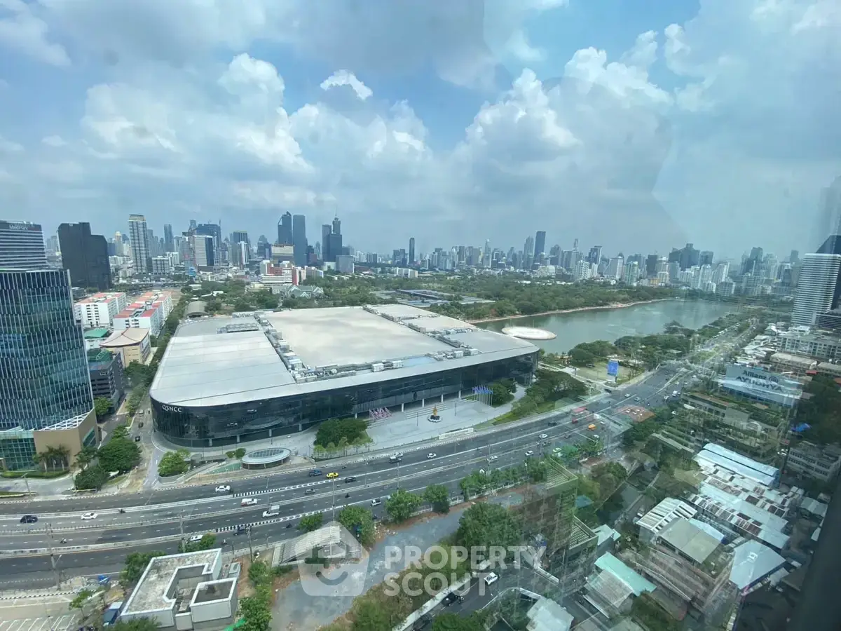 Stunning cityscape view from high-rise building with lush greenery and urban skyline.