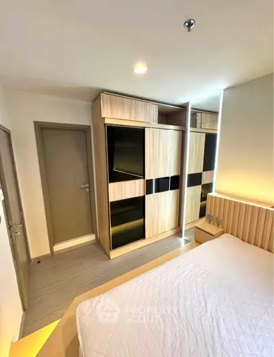 Modern bedroom with sleek wardrobe and cozy lighting