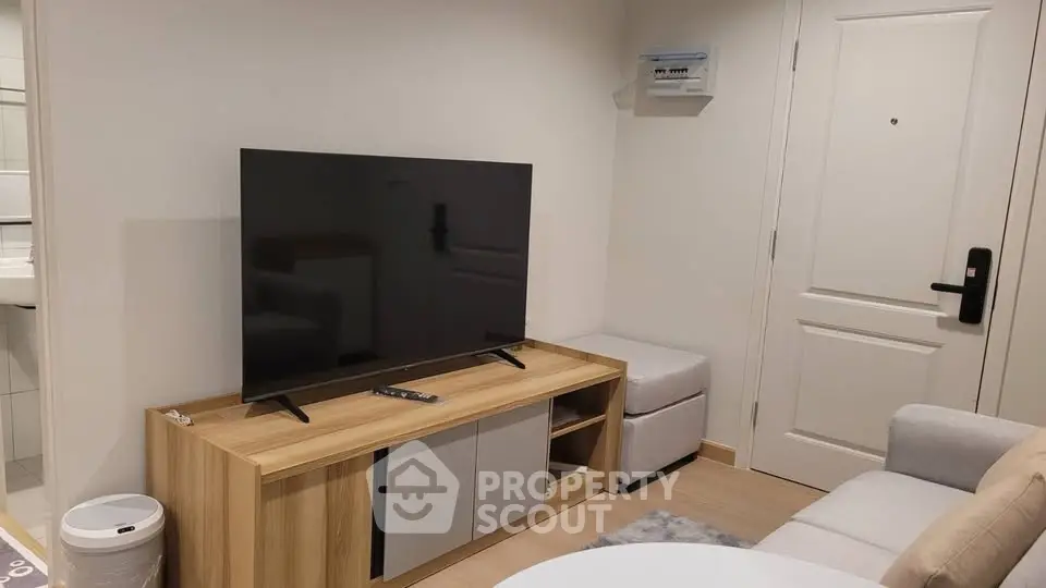 Modern living room with sleek TV and stylish furniture