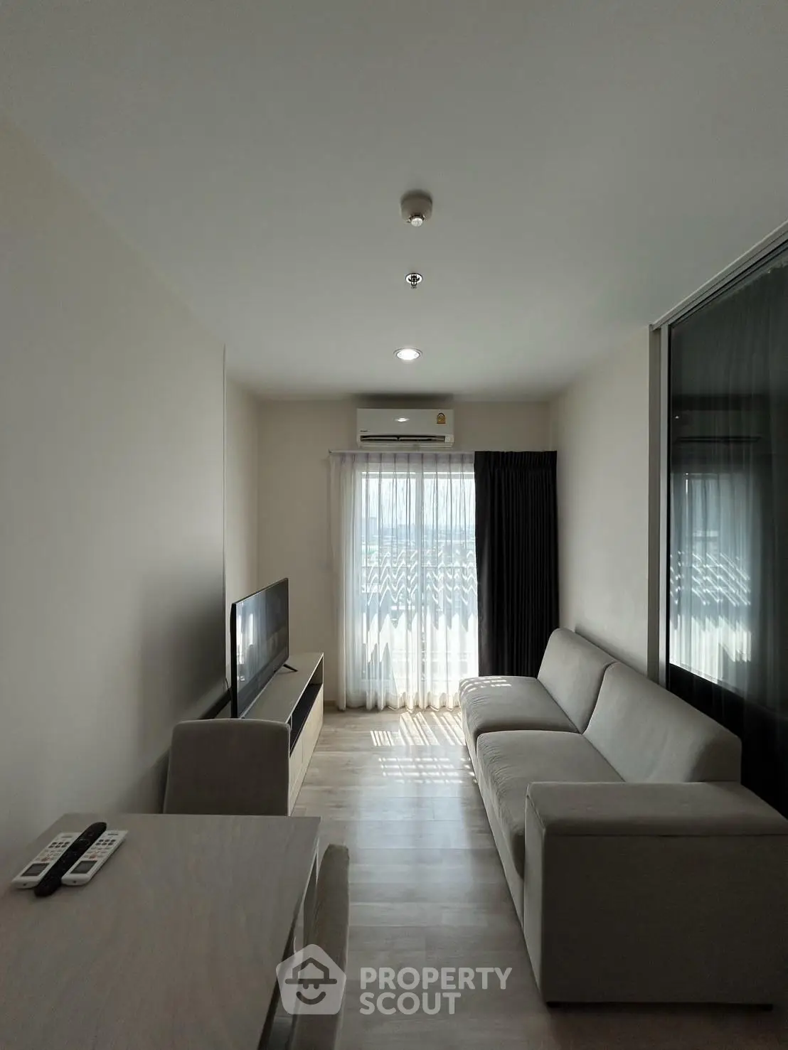 Modern living room with sleek furniture and natural light, perfect for relaxation and entertainment.