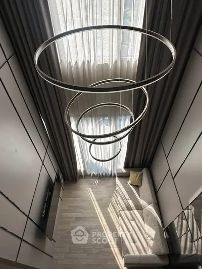 Modern living room with high ceiling and stylish lighting