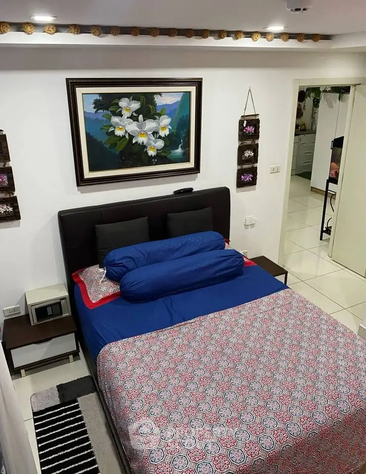 Cozy bedroom with modern decor and vibrant bedding