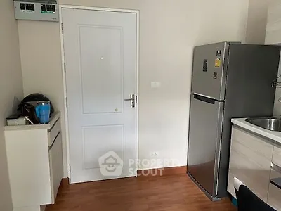Compact modern kitchen with stainless steel appliances and ample storage space, perfect for urban living.